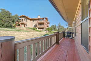 Wooden terrace with a lawn and grilling area