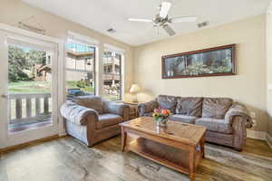 Living room featuring ceiling fan and hardwood / wood-style floors