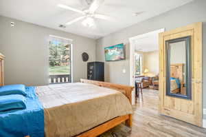 Bedroom with light hardwood / wood-style flooring and ceiling fan