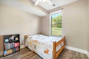 Bedroom featuring dark wood-type flooring and ceiling fan