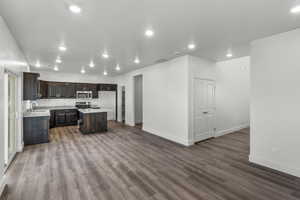 Kitchen featuring a center island, dark hardwood / wood-style floors, sink, and dark brown cabinetry