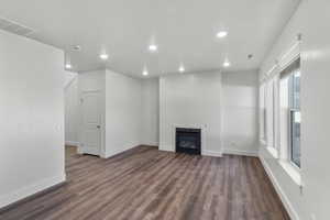 Unfurnished living room with dark hardwood / wood-style floors