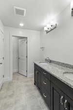 Bathroom featuring vanity and tile patterned floors