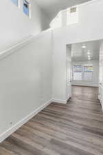 Unfurnished room featuring a high ceiling and dark hardwood / wood-style floors