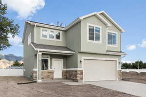 View of front of property featuring a mountain view and a garage