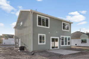 Rear view of house with cooling unit and a patio area