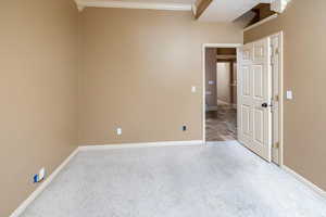 Bedroom #6 with crown molding and light colored carpet