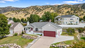 View of front facade with a front lawn and a mountain view