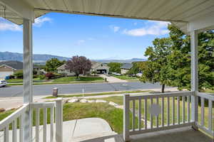 View of patio with a mountain view and a porch