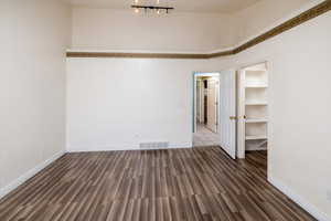 Primary bedroom  with dark wood-type flooring