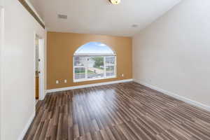 Unfurnished room featuring dark wood-type flooring