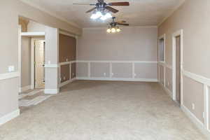 Unfurnished room with a textured ceiling, light carpet, and ceiling fan