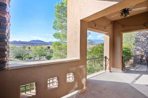 Balcony featuring ceiling fan and a mountain view