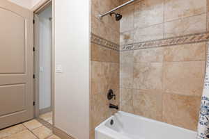 Bathroom with shower / bath combination with curtain