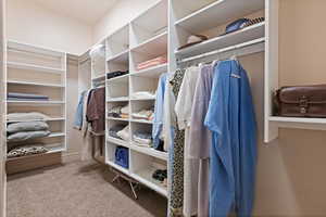 Walk in closet featuring carpet flooring