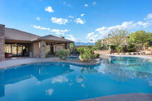 View of swimming pool with a patio area and a mountain view