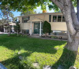 Split foyer home featuring a front yard