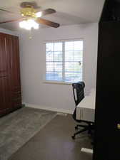 Office area featuring carpet flooring and ceiling fan