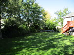 View of yard with a wooden deck