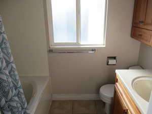 Master Full bathroom featuring vanity, toilet, shower / bath combination with curtain, and tile patterned floors