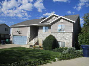 View of front of home featuring a garage and a front lawn