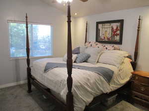 master Bedroom with ceiling fan, vaulted ceiling, and carpet floors