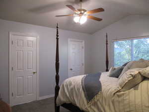 Master bedroom with lofted ceiling and ceiling fan