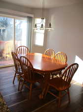 Dining area with a chandelier and hardwood / wood-style flooring