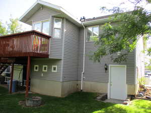 Rear view of property with basement entrance.