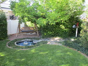 View of yard featuring a fountain and swing chair