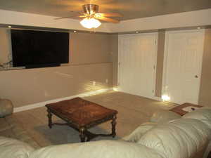 Living room with ceiling fan and carpet