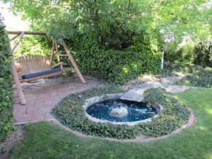 View of yard with a small fountain/pond.