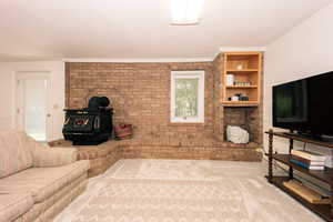 Living room featuring ornamental molding and carpet flooring