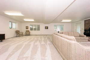 Carpeted living room featuring a healthy amount of sunlight