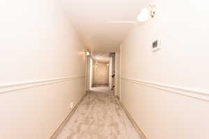 Hallway with light colored carpet