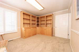 Den/Office with ornamental molding and light colored carpet