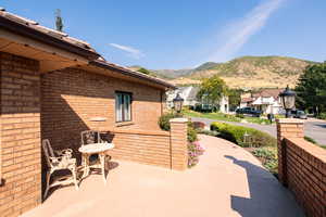 View of partially covered patio / terrace featuring a mountain view