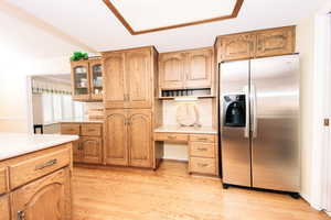 Kitchen featuring stainless steel fridge and light hardwood / wood-style floors