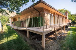 View of side of home with central AC and a yard