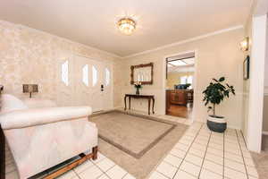 Living room with crown molding and plenty of natural light