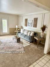 Carpeted living room with ornamental molding