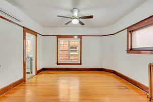 Dining area featuring ceiling fan, light wood flooring, and a wall mounted air conditioner