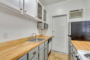 Kitchen featuring butcher block countertops, stainless steel appliances