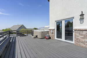 Wooden terrace featuring a hot tub