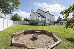 View of yard featuring a wooden deck, central AC unit, and an outdoor fire pit