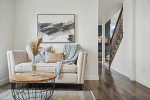 Living area with dark wood-type flooring