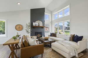 Living room featuring plenty of natural light, hardwood / wood-style floors, and a fireplace