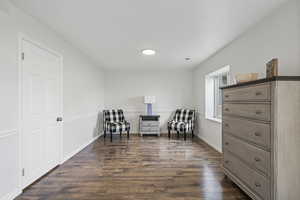 Living area with dark hardwood / wood-style floors