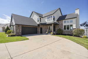 View of front of home with a front lawn and a garage