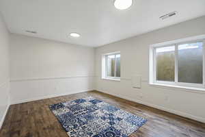 Empty room featuring wood-type flooring